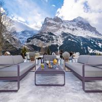 a room with two couches and a table and a mountain at Sunstar Hotel & SPA Grindelwald