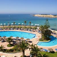 an overhead view of a swimming pool with umbrellas and the ocean at Regency Hotel & Spa, Monastir