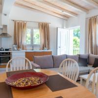 a kitchen and living room with a table and a couch at Apartment Sofia - Beachfront, St. Spyridon Corfu