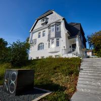 a large white house with stairs leading up to it at LIONO BoutiqueHotel, Goslar