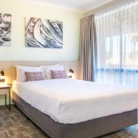 a bedroom with a large bed and a large window at Nightcap at Wanneroo Tavern