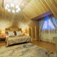 a bedroom with a bed and a chandelier at Svetliy Terem Hotel, Suzdal