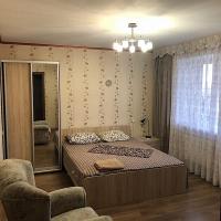 a bedroom with a bed and a large mirror at Квартира № 216 вулиця Старообрядницька 3, Kherson