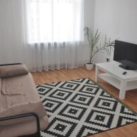 a living room with a couch and a tv and a table at Apartments Theatre Shepkina 2 room, Sumy
