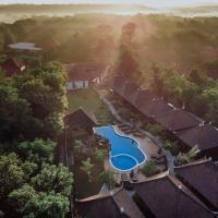 an aerial view of a resort with a pool and trees at Mamamia Island Villa, Nusa Lembongan