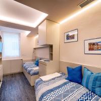 two beds in a dorm room with blue pillows at La Casetta di Portofino by PortofinoVip