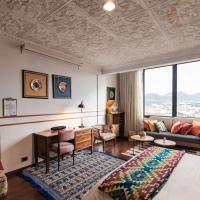 a hotel room with a bed and a desk at Selina Cuenca