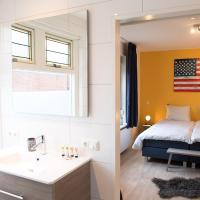 a bathroom with a bed and a sink and a mirror at Shortstay Bilderdijk, Enschede