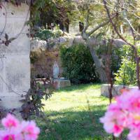 a garden with pink flowers in the grass at Centro di Spiritualità Madonna della Nova, Ostuni