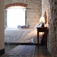 a bedroom with a bed and a window at Drommire In Plassa E Clesia, Baunei