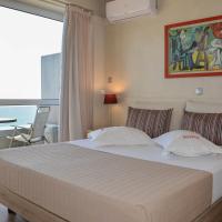 a bedroom with a bed with a view of the ocean at Scorpios Sea Side Hotel, Piraeus