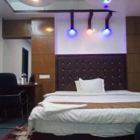 a bedroom with a bed and a chair and lights at HOTEL BLUE BIRD, Dhaka