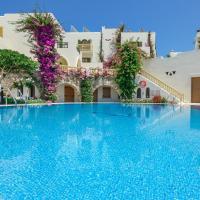 a swimming pool in front of a building at Proteas Hotel & Suites, Agios Prokopios