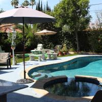 a swimming pool with an umbrella and a table and chairs at Sweet Dreams B&B LA, Sherman Oaks