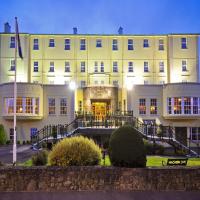 a large white building with its lights on at Sligo Southern Hotel & Leisure Centre