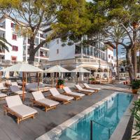 a resort pool with lounge chairs and umbrellas at Hoposa Uyal, Port de Pollensa