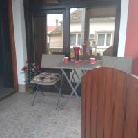 a patio with a table and chairs on a porch at Apartments Barocco, Golubac