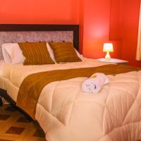 a bedroom with a large bed with a towel on it at Residencial el Valle, Huaraz