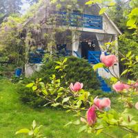 a house with pink flowers in front of it at Romantic Eco Holiday Home, Píkovice