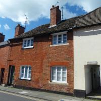a red brick house on the side of a street at The Little House, Devizes