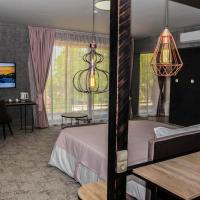 a hotel room with a bed and a living room at Clepsydra Residence, Plovdiv