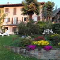 a garden in front of a house with flowers at Giardino, Porto Valtravaglia