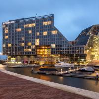 a large building next to a river with buildings at Room Mate Aitana, Amsterdam