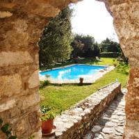 a stone wall with a view of a swimming pool at Byzantion Hotel, Mystras