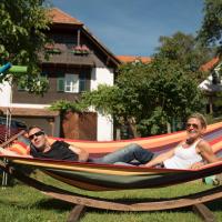 two men laying in a hammock in a yard at Bio-Hof Windhaber, Stubenberg