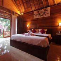 a bedroom with a large bed in a wooden room at Kamasan Cottage, Nusa Penida