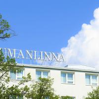 a sign on the top of a building with trees at Hotel Raumanlinna