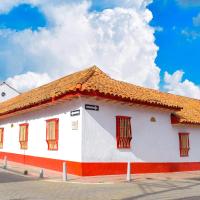 a white building with an orange roof on a street at Hotel Cacique Real, Zipaquirá