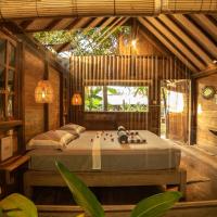 a bedroom with a bed in a wooden house at Musa Villas and Bungalows Gili Air, Gili Islands
