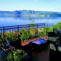 a balcony with chairs and a view of a lake at Carobni breg, Golubac