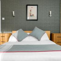 a bedroom with a large bed with two pillows at Flexistay Tulsi Aparthotel, Croydon