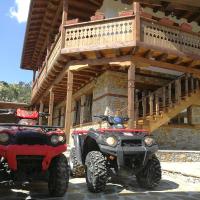 two atvs parked next to a building with a balcony at Слънчевата къща, Kovačevica