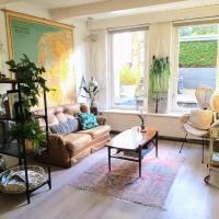 a living room with a couch and a table at Charming house near the Beach in Bloemendaal