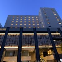 a tall black building with two tall buildings at Oriental Hotel Fukuoka Hakata Station
