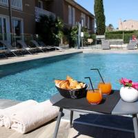 a table with bread and drinks next to a swimming pool at Best Western Plus Hyères Côte D'Azur