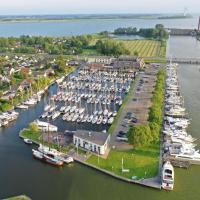 an aerial view of a marina with boats in the water at Hotel Iselmar, Lemmer