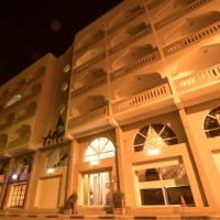 a large building with windows at night at Atlantic Hotel, Djibouti