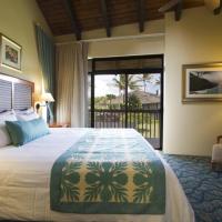 a bedroom with a bed and a chair and a window at Club Wyndham Ka Eo Kai, Princeville