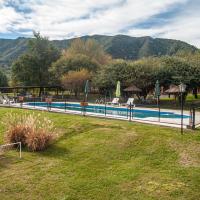 a swimming pool in a yard next to a house at Cerro de los Duendes, Santa Rosa de Calamuchita