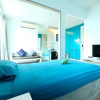 a bedroom with a blue bed and a television at D@Sea Hotel, Jomtien Beach