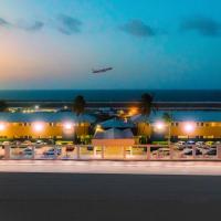 an airplane is flying over an airport at night at Curacao Airport Hotel, Willemstad