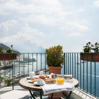 a table on a balcony with a view of the water at Hotel Il Nido, Amalfi