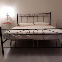 a black bed with white sheets and pillows on it at L' Antico Comune, Cavriglia