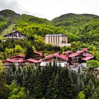 a group of houses on a hill with trees at Hotel Bistra, Resort Mavrovo