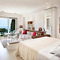 a white bedroom with a bed and a living room at Hotel Villa Belvedere, Taormina