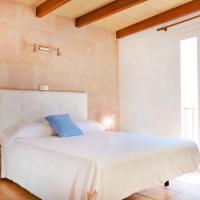 a bedroom with a white bed with a blue pillow at Marblau Mallorca, Cala Figuera